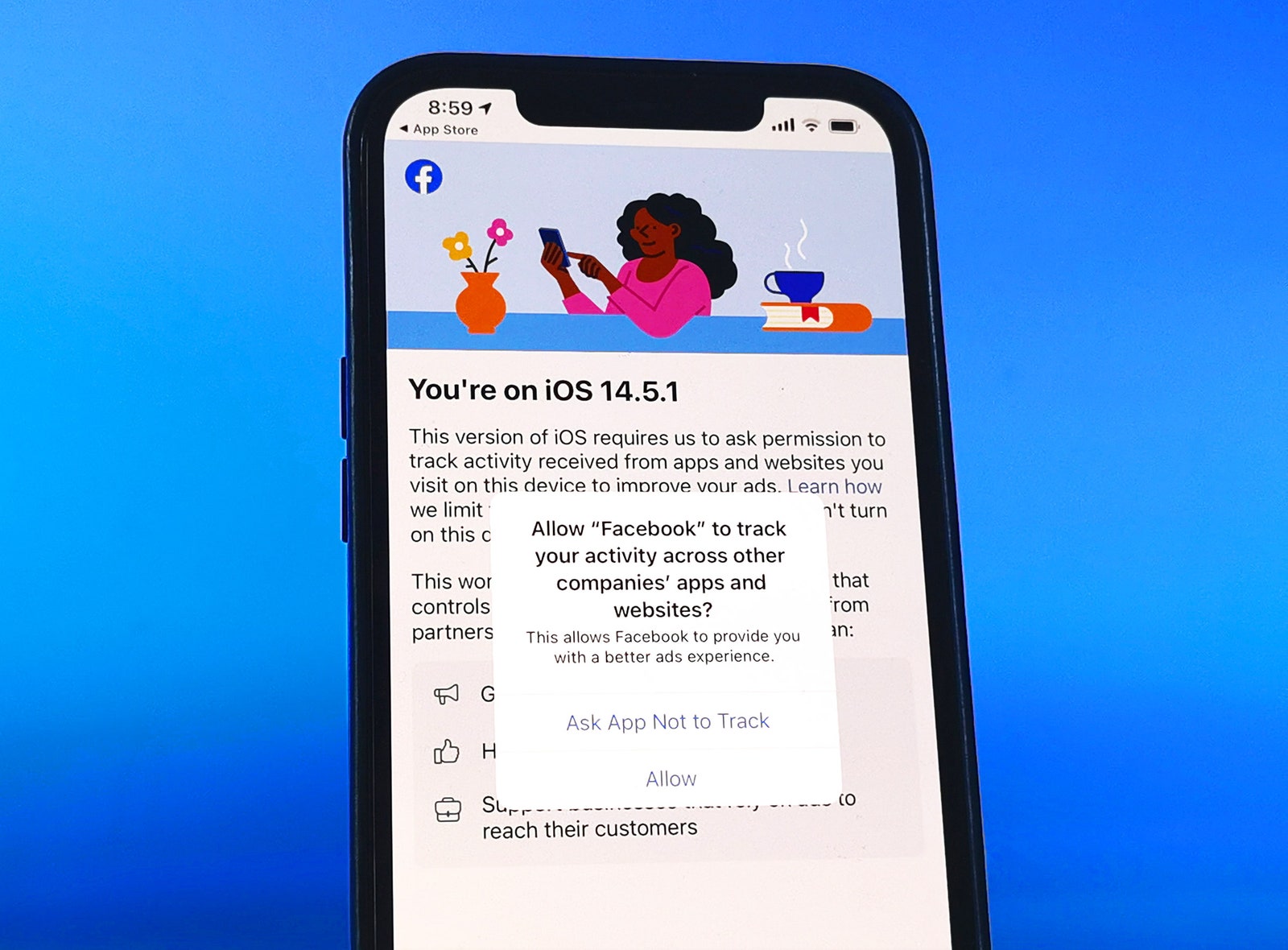 iPhone screen with Facebook app open and Apple's Ask App Not to Track popup in front phone on blue background