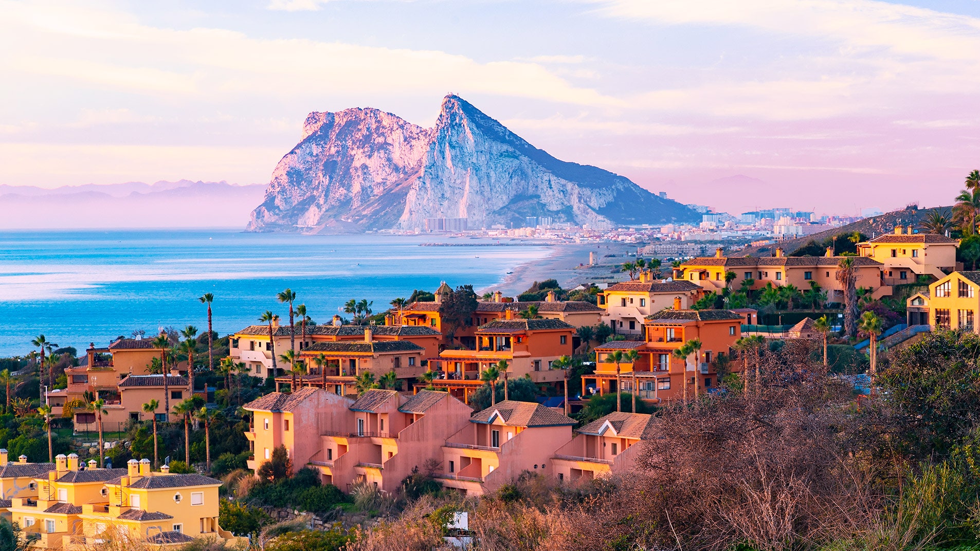 Houses on a hill overlooking The Rock of Gibraltar