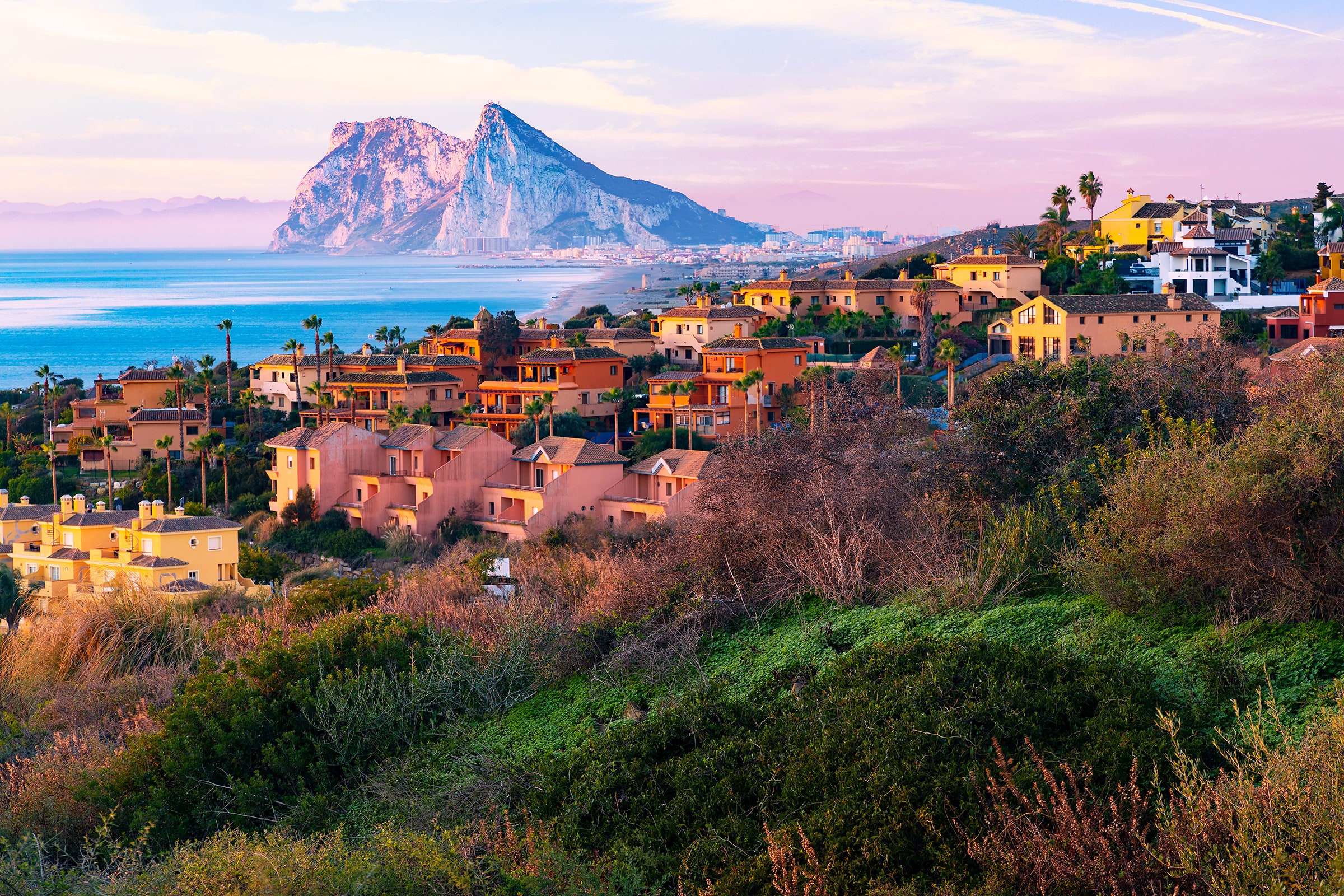 Houses on a hill overlooking The Rock of Gibraltar