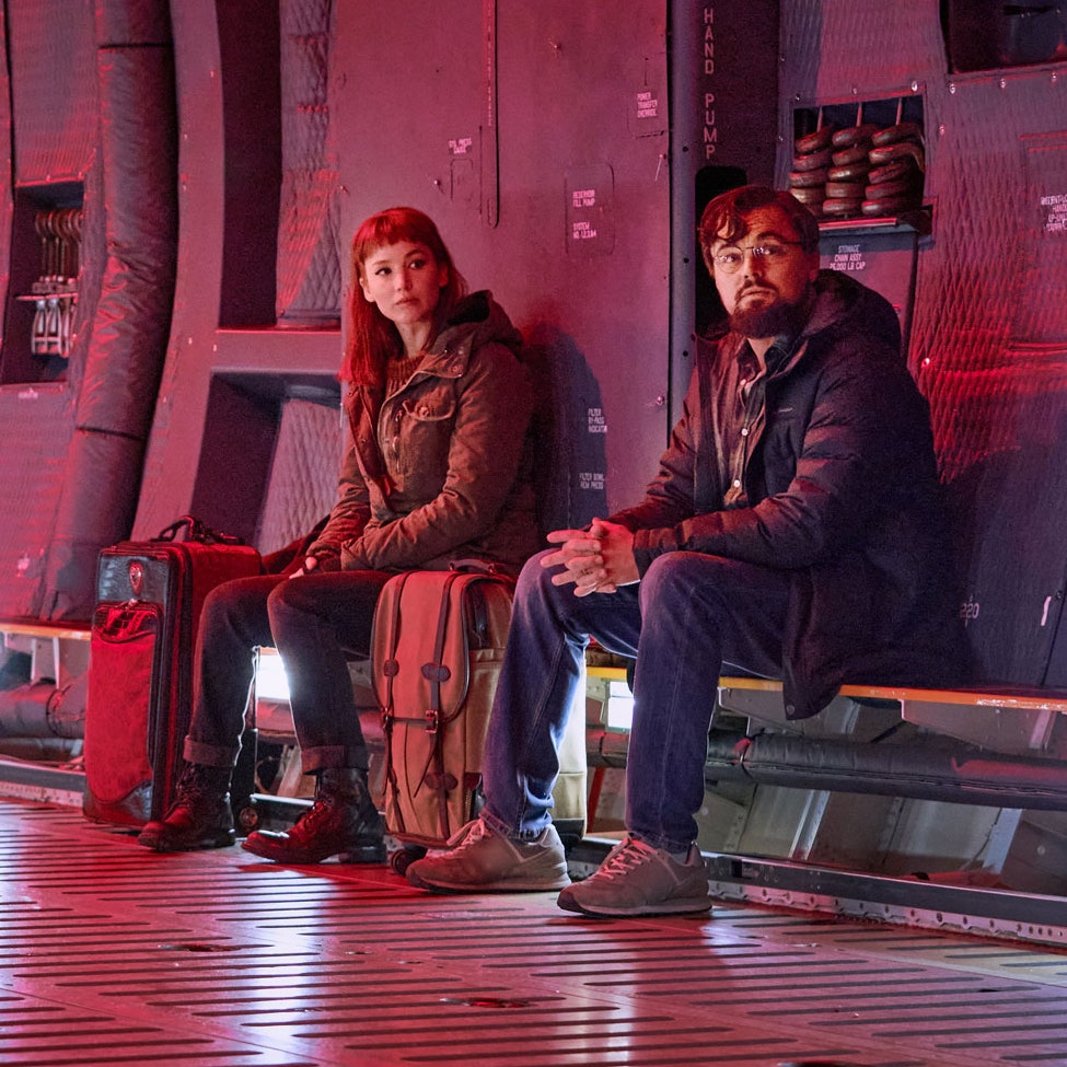 Movie still from 'Don't Look Up' showing Leonardo DiCaprio and Jennifer Lawrence sitting in lab setting