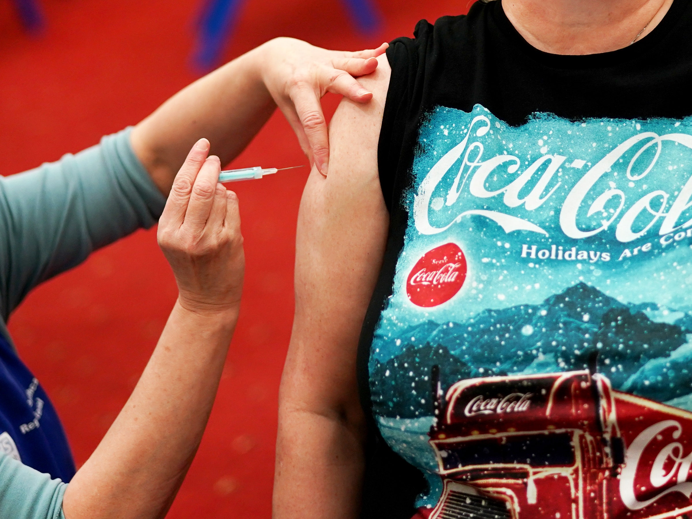 Nurse giving COVID-19 booster vaccine to patient