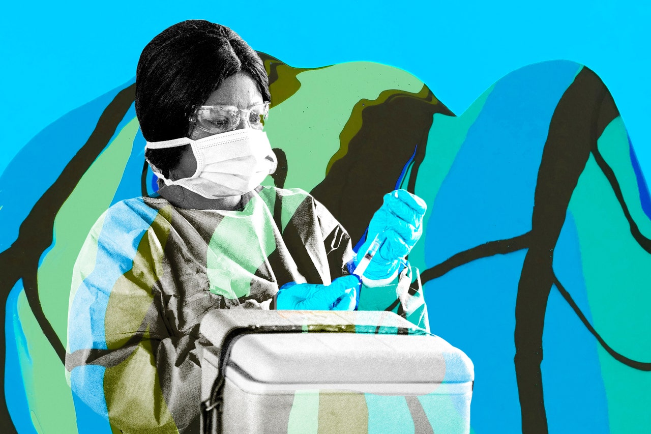 medical staff wearing rubber gloves face mask and goggles holding a vaccine and standing in front of a cooler